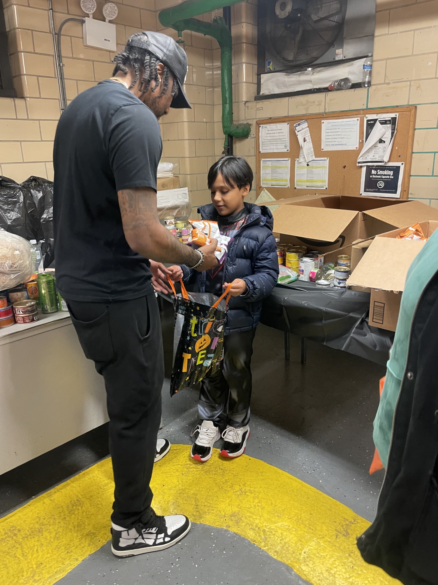 Foundation member helping a child at a food drive